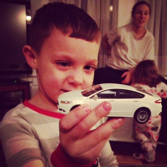 Mason with the toy Ford Fusion