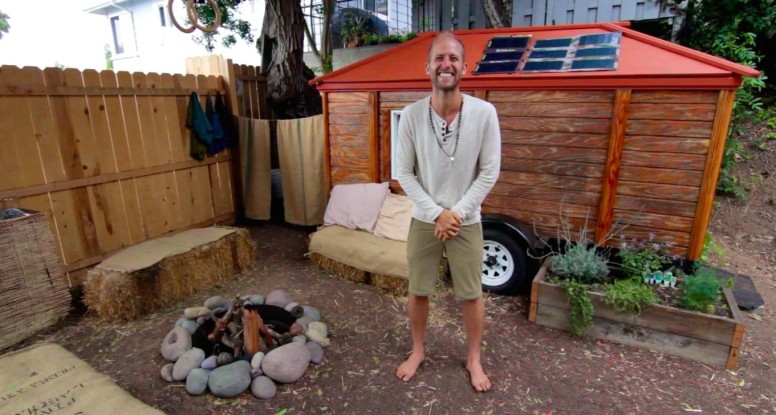 Rob Greenfield next to his off grid tiny house