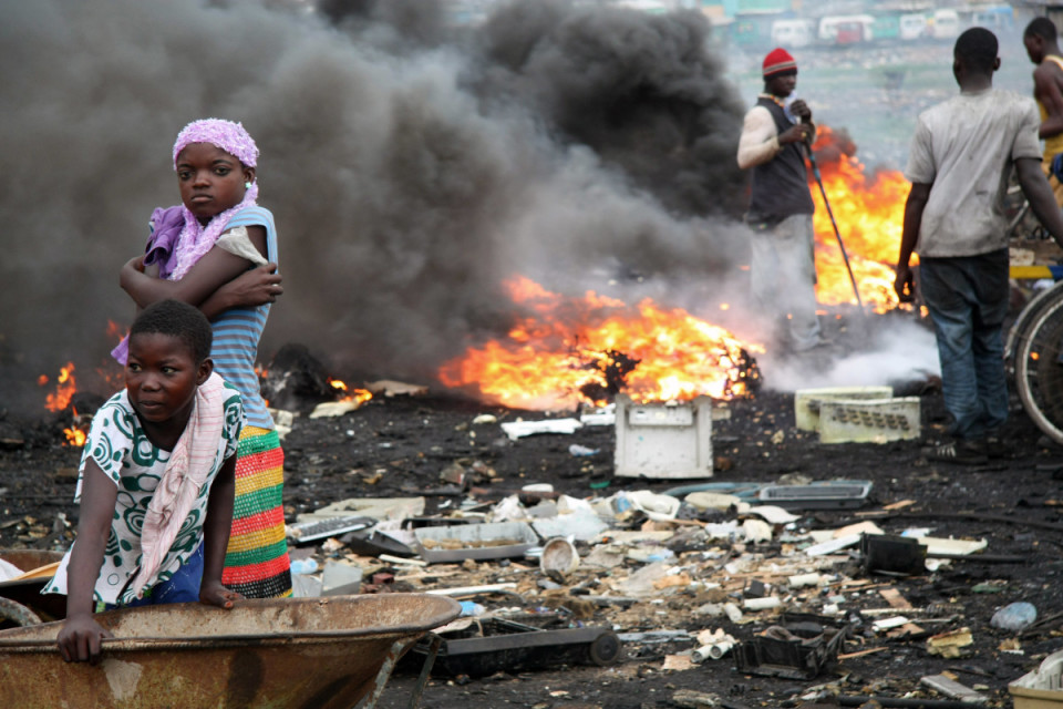 In Agbogbloshie, Ghana, locals burn scrap wires and other electronic waste (e-waste) at informal processing areas to extract the valuable copper within. The burning poisons the landscape and releases large amounts of toxic fumes into the air, which settle into the water and ground and contaminated food sold in the nearby markets. Agbogbloshie is one of the largest e-waste dumpsites in Africa. Photo credit: Dr. Jack Caravanos