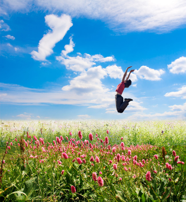 Woman Jumping in field