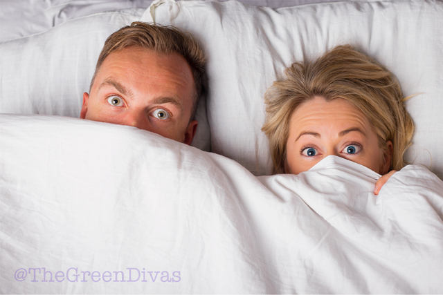 couple in bed pondering bamboo sheets on the green divas